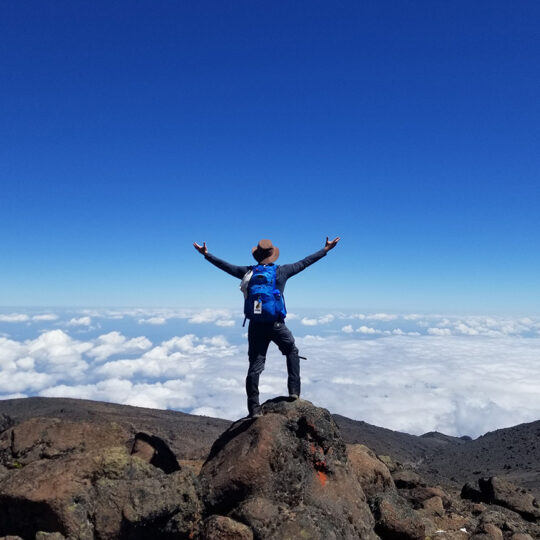 hiker above clouds on mount kilimanjaro