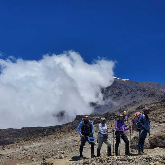 trekkers in alpine desert zone on kilimanjaro