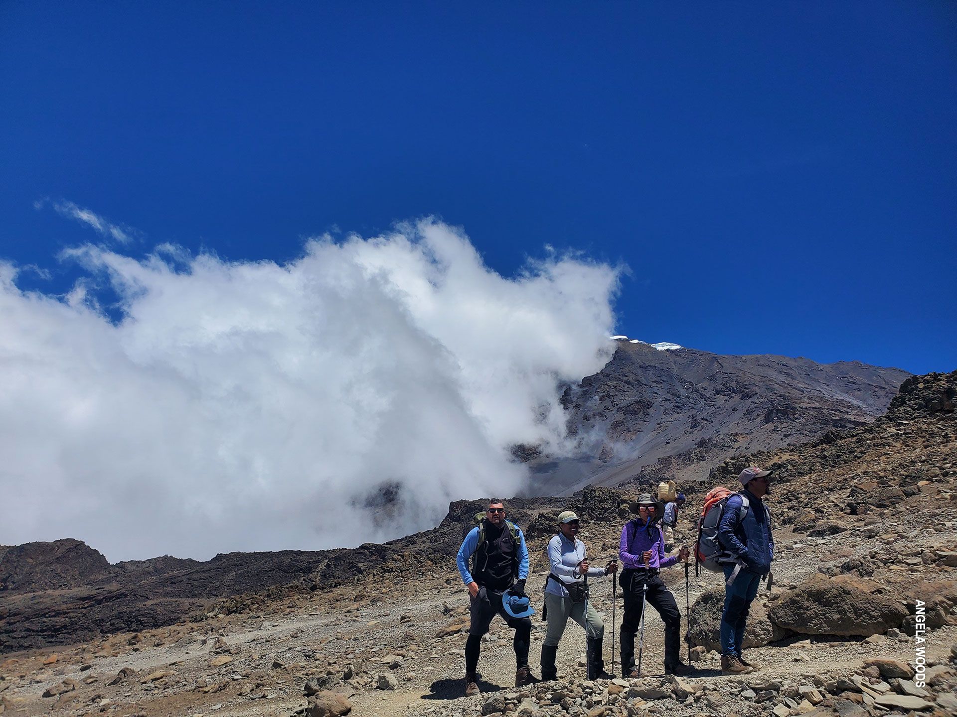 trekkers in alpine desert zone on kilimanjaro